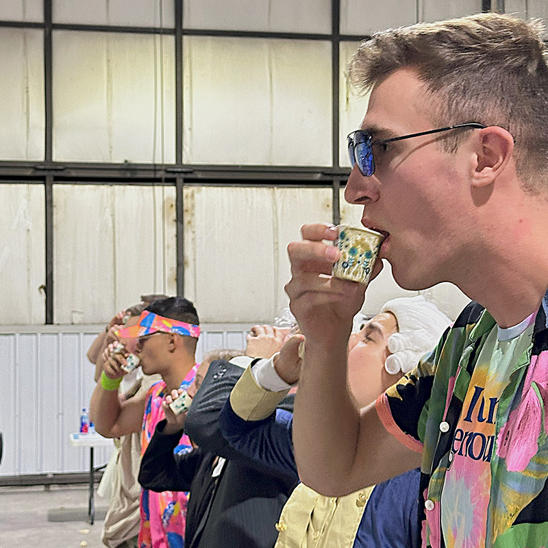 Cadets take a sip of a drink at Dining In