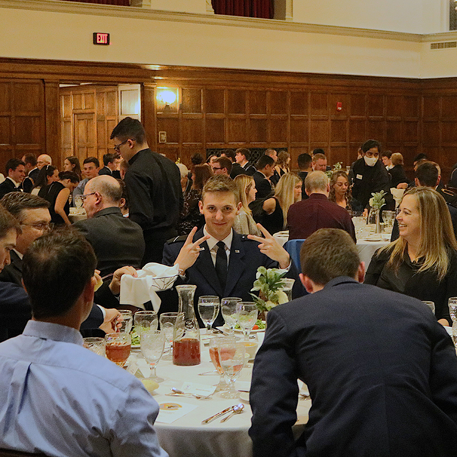 Cadets seated around a table at Dining Out