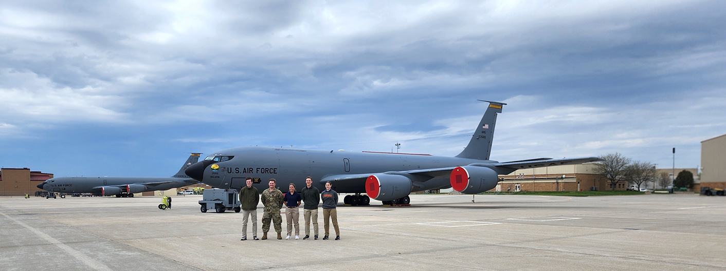 Cadets pose in front of an Air Force plane